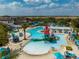Aerial view of a community pool area with slides, a splash pad, and plenty of seating at 1909 Majorca Dr, Kissimmee, FL 34747