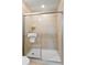 A modern bathroom features a step-in shower with a glass door and tile surround at 1909 Majorca Dr, Kissimmee, FL 34747
