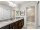 Bathroom featuring a double vanity with granite countertop and a glass-enclosed shower at 1909 Majorca Dr, Kissimmee, FL 34747