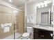 Bathroom with granite counter, tiled shower with a glass door and shower head at 1909 Majorca Dr, Kissimmee, FL 34747