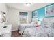 Bedroom featuring two twin beds with seashell bedding and bright colored accent wall and artwork at 1909 Majorca Dr, Kissimmee, FL 34747