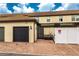 Exterior of townhome with a private garage, a brick driveway, and private parking at 1909 Majorca Dr, Kissimmee, FL 34747