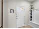 Bright foyer features a white front door with sidelight, neutral walls and built-in shelving at 1909 Majorca Dr, Kissimmee, FL 34747