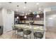 Well-appointed kitchen boasts granite countertops, stainless steel appliances, and seating at the island at 1909 Majorca Dr, Kissimmee, FL 34747
