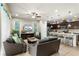 Open concept living room and kitchen featuring neutral tile floors and modern decor at 1909 Majorca Dr, Kissimmee, FL 34747