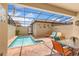 Private pool area with a screened-in enclosure, brick pavers, and lounge chairs at 1909 Majorca Dr, Kissimmee, FL 34747