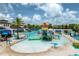 Community pool area with splash pad, slides, covered seating, and lots of lounge chairs at 1909 Majorca Dr, Kissimmee, FL 34747