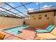 Private pool with screened enclosure, brick pavers, and lounge chairs in backyard at 1909 Majorca Dr, Kissimmee, FL 34747