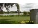 A serene lakeside view from the backyard, featuring calm water and natural surroundings at 1952 English Dr, Deltona, FL 32738