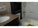 Cozy bathroom with tub, granite vanity, and built in shelves providing ample storage at 1952 English Dr, Deltona, FL 32738