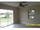 Neutral living room with lots of natural light, ceramic floors, and sliding glass door access to backyard at 1952 English Dr, Deltona, FL 32738