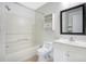 Bright bathroom featuring a shower-tub combo, a toilet, a single sink vanity, and a wall cabinet at 2053 Dixie Belle Dr # 2053J, Orlando, FL 32812