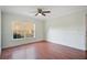 Bright bedroom with hardwood floors, crown molding, and a large window overlooking the yard at 2053 Dixie Belle Dr # 2053J, Orlando, FL 32812