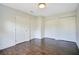 Bedroom featuring hardwood floors and multiple closets, providing ample storage space at 2053 Dixie Belle Dr # 2053J, Orlando, FL 32812