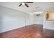 Spacious living room with hardwood floors and a view to the kitchen and the unit entrance at 2053 Dixie Belle Dr # 2053J, Orlando, FL 32812