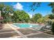 A refreshing community pool surrounded by lush landscaping and comfortable lounge chairs at 2053 Dixie Belle Dr # 2053J, Orlando, FL 32812