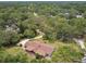 Expansive aerial view of a home nestled amongst lush, mature trees at 207 S Sweetwater Blvd, Longwood, FL 32779