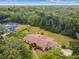 A bird's eye view of a home situated in a lush, green, and wooded area at 207 S Sweetwater Blvd, Longwood, FL 32779