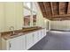 Covered outdoor kitchen area features a wet bar with a sink, and storage space at 207 S Sweetwater Blvd, Longwood, FL 32779