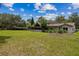 Expansive backyard with a screened-in porch and a backdrop of lush trees at 207 S Sweetwater Blvd, Longwood, FL 32779
