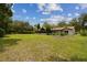 A spacious, well-maintained backyard with a screened-in porch at 207 S Sweetwater Blvd, Longwood, FL 32779