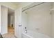 Bathroom featuring a white tub and shower with white tile surround at 207 S Sweetwater Blvd, Longwood, FL 32779