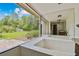 Bright bathroom features a soaking tub with mosaic tile and a large window overlooking the backyard at 207 S Sweetwater Blvd, Longwood, FL 32779