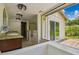 Bright bathroom features a soaking tub with mosaic tile, granite countertops and walk out to back yard at 207 S Sweetwater Blvd, Longwood, FL 32779