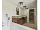 Bright bathroom features a soaking tub with mosaic tile and dual sink vanity with granite countertops at 207 S Sweetwater Blvd, Longwood, FL 32779