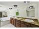 Bathroom features a large vanity with double sinks and a soaking tub at 207 S Sweetwater Blvd, Longwood, FL 32779
