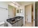 Bathroom featuring double sinks with marble countertops and white cabinets at 207 S Sweetwater Blvd, Longwood, FL 32779