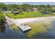 Aerial view of lakeside beach area with playground, swimming area, picnic tables and pier at 207 S Sweetwater Blvd, Longwood, FL 32779