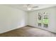 This carpeted bedroom features a ceiling fan and a view of the front yard at 207 S Sweetwater Blvd, Longwood, FL 32779
