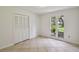 This bedroom has tile flooring, a double closet, and a view of the front yard at 207 S Sweetwater Blvd, Longwood, FL 32779