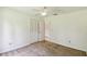 Bright bedroom featuring a ceiling fan and closet with white bi-fold doors at 207 S Sweetwater Blvd, Longwood, FL 32779