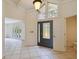 Bright foyer with high ceilings and a glass front door opens into a living room with large windows at 207 S Sweetwater Blvd, Longwood, FL 32779