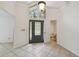View of the home's foyer featuring tiled floors, high ceilings and a stained glass front door at 207 S Sweetwater Blvd, Longwood, FL 32779