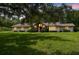 Charming single-story home boasts a lush front yard, mature trees, and a brick facade entry at 207 S Sweetwater Blvd, Longwood, FL 32779