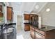 View of the bright kitchen with granite counters, a center island and stainless steel refrigerator at 207 S Sweetwater Blvd, Longwood, FL 32779