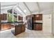 Spacious kitchen with stainless steel refrigerator, center island, and plenty of natural light at 207 S Sweetwater Blvd, Longwood, FL 32779