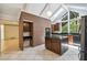 Bright kitchen with modern appliances, island, and brick accent wall beneath skylights at 207 S Sweetwater Blvd, Longwood, FL 32779