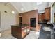 View of bright kitchen showcasing granite counters, center island, and brick oven wall at 207 S Sweetwater Blvd, Longwood, FL 32779