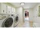 Laundry room with side-by-side washer and dryer and a view into kitchen at 207 S Sweetwater Blvd, Longwood, FL 32779