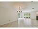 Expansive living room featuring tile floors and neutral walls, enhanced by an elegant chandelier at 207 S Sweetwater Blvd, Longwood, FL 32779