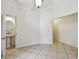 Bright living room featuring tiled floors and neutral walls with an open doorway to the adjacent half bathroom at 207 S Sweetwater Blvd, Longwood, FL 32779