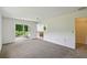 Open-concept living room with sliding glass doors and a view of the kitchen at 207 S Sweetwater Blvd, Longwood, FL 32779