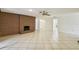 Spacious living room features a brick fireplace and neutral tile flooring at 207 S Sweetwater Blvd, Longwood, FL 32779
