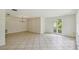 Spacious living room with tile floors, neutral walls, and views of the outdoor greenery through the windows at 207 S Sweetwater Blvd, Longwood, FL 32779