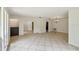 Open-concept living room featuring tiled floors, neutral walls, and seamless transitions to the adjacent rooms at 207 S Sweetwater Blvd, Longwood, FL 32779