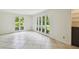 Bright living area featuring tile floors and large windows offering a view of the lush greenery at 207 S Sweetwater Blvd, Longwood, FL 32779